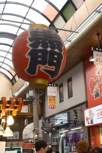 Giant red lantern hanging in an Osaka market arcade