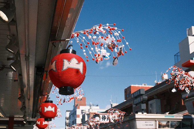 Red lanterns and festive decorations against a blue sky in Tokyo